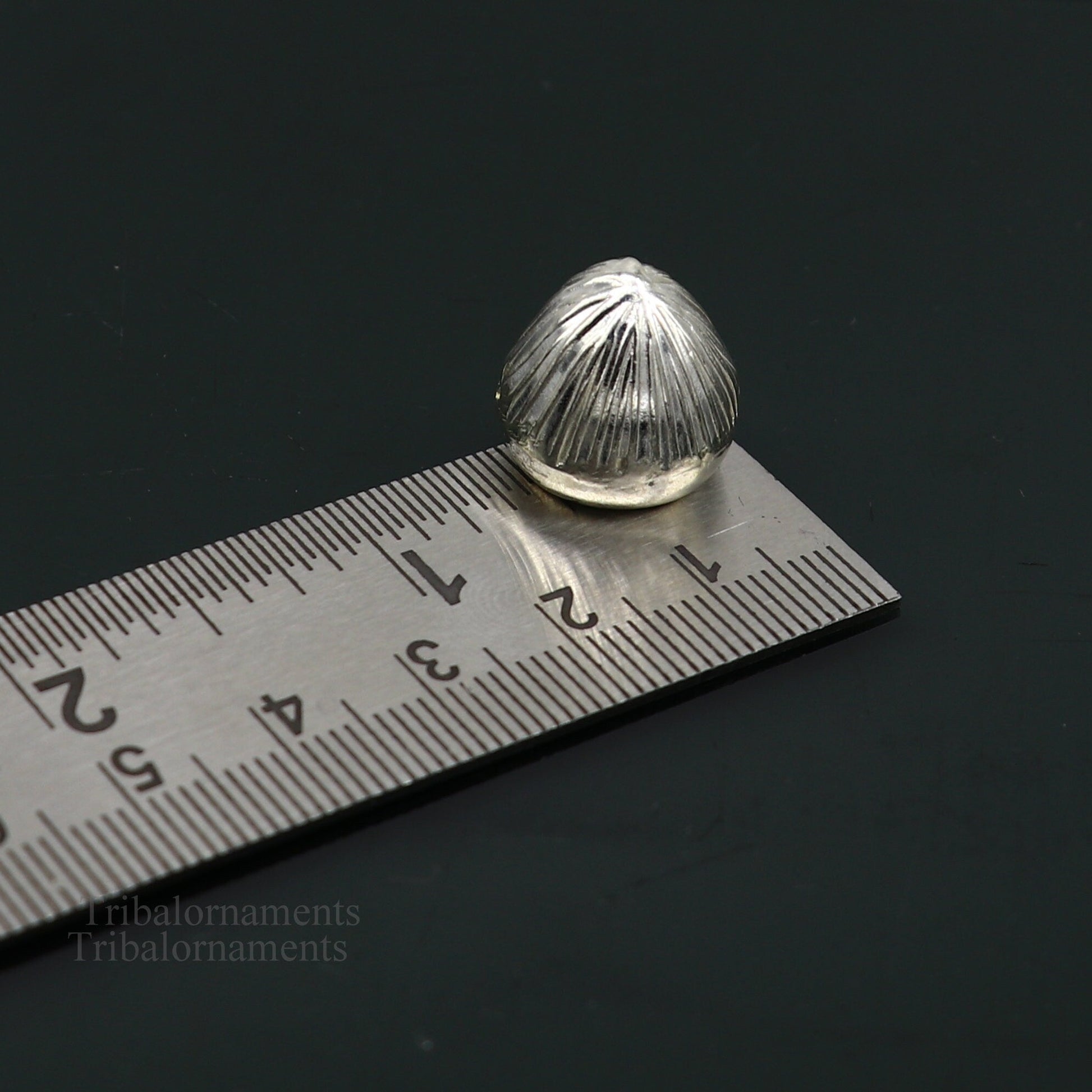 Sterling silver handmade Betal palm tree seed Supari, a traditional puja article from Tribal Ornaments, used in worship ceremonies.