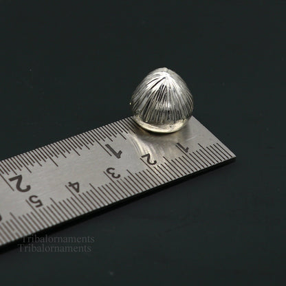 Sterling silver handmade Betal palm tree seed Supari, a traditional puja article from Tribal Ornaments, used in worship ceremonies.