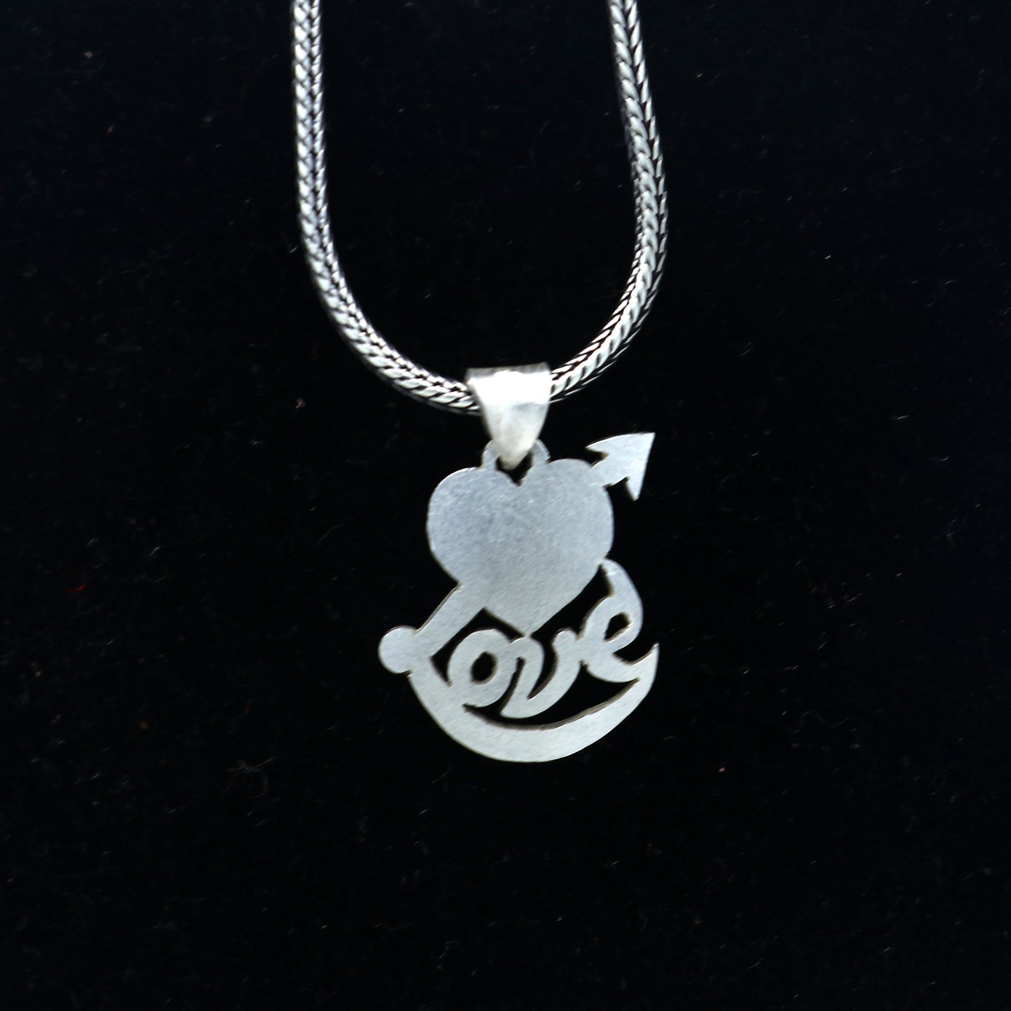 925 Sterling silver pendant with diamond heart and love design from TRIBAL ORNAMENTS, showcasing intricate craftsmanship and sparkling accents.