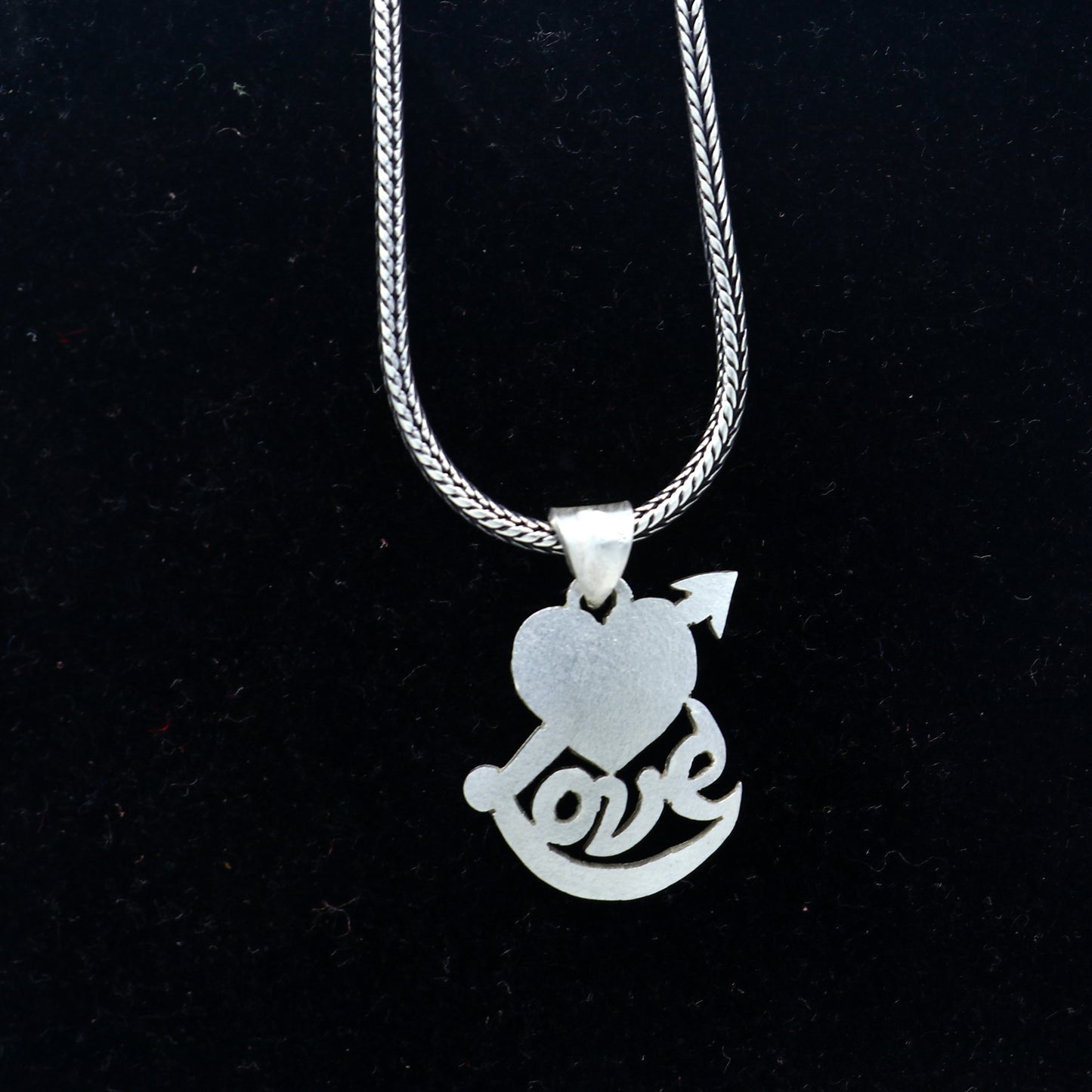 925 Sterling silver pendant featuring a diamond heart and love design, crafted by TRIBAL ORNAMENTS.