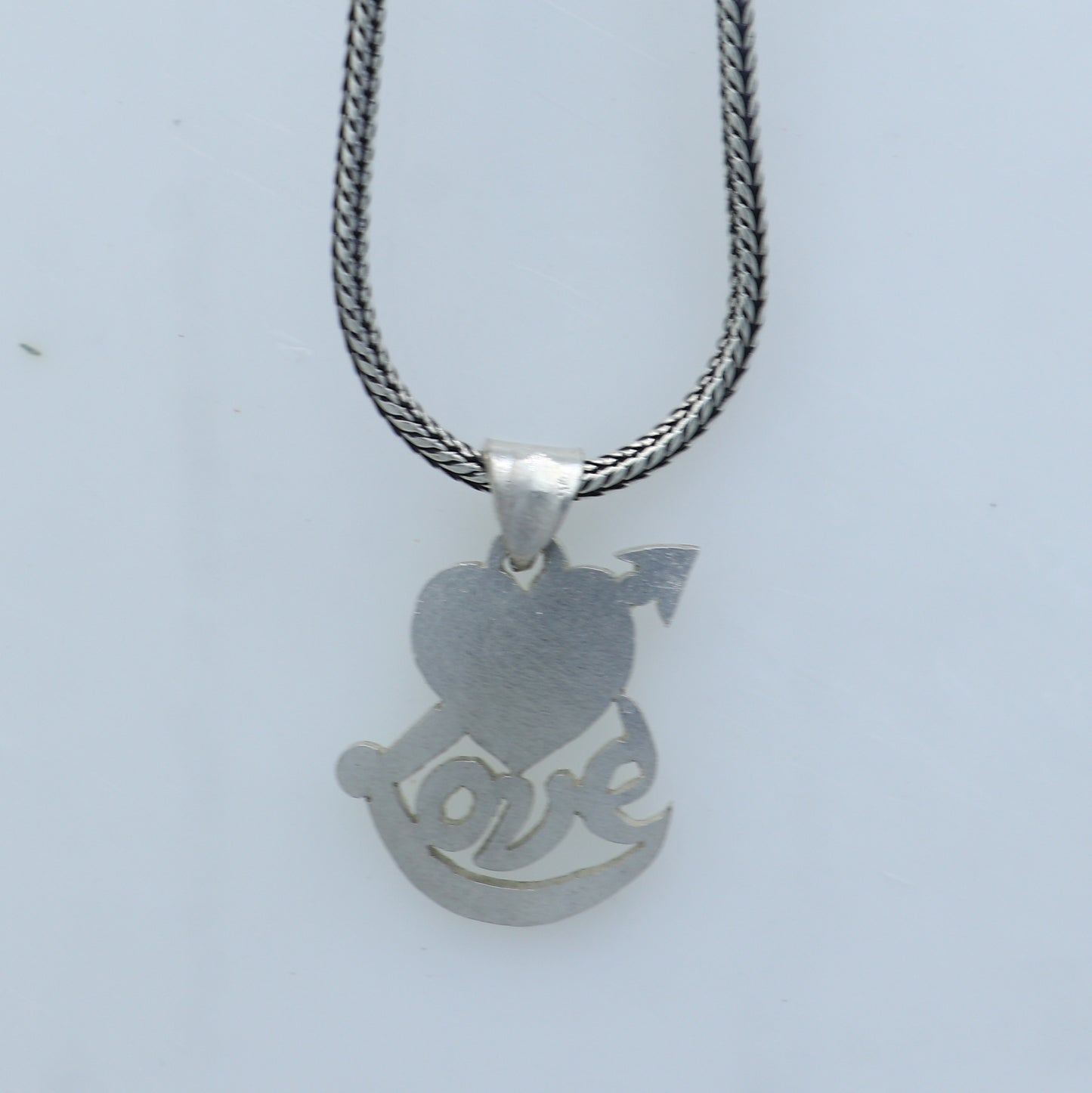 925 Sterling silver pendant featuring a diamond heart and love design, crafted by TRIBAL ORNAMENTS.