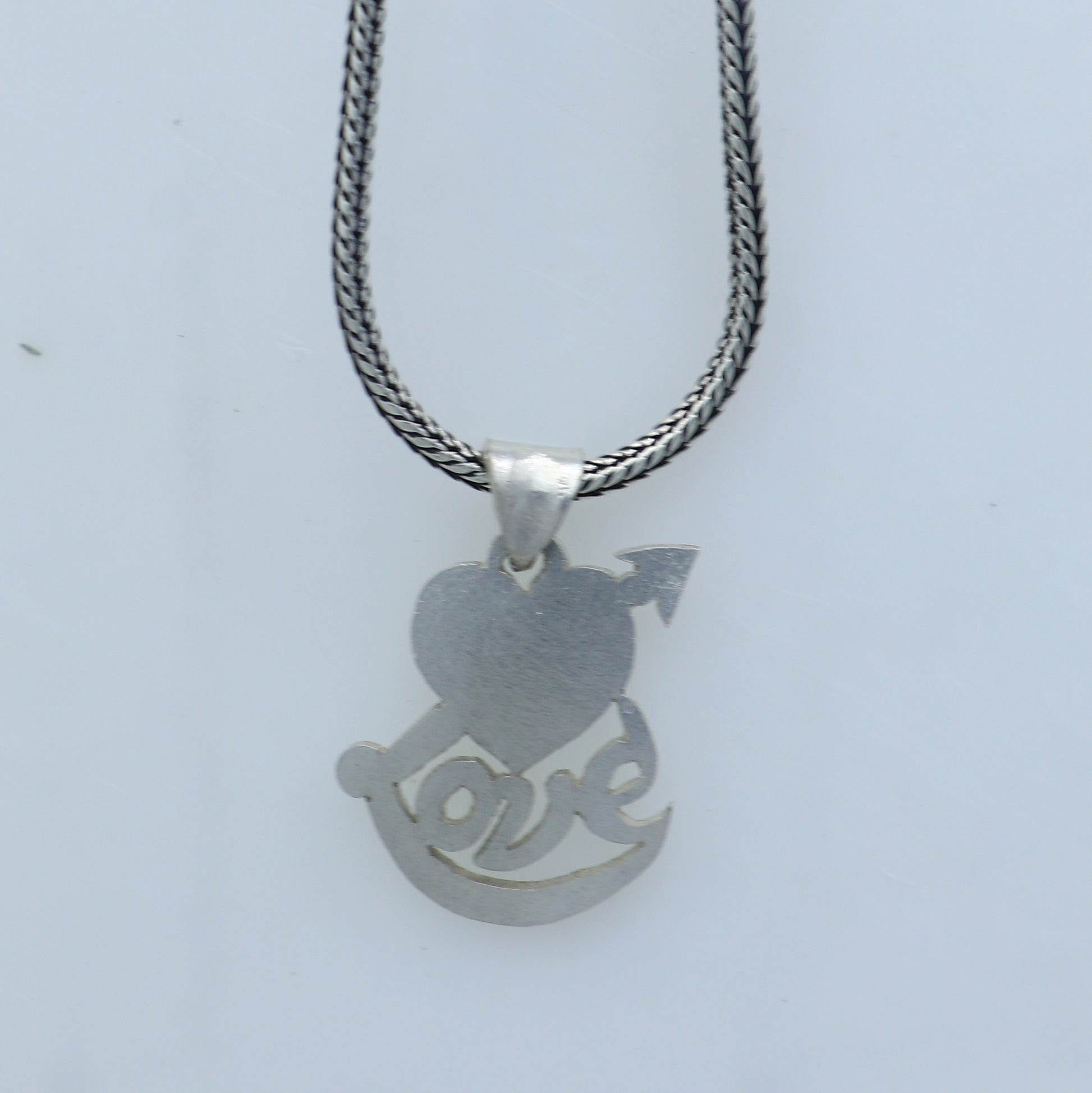 925 Sterling silver pendant featuring a diamond heart and love design, crafted by TRIBAL ORNAMENTS.