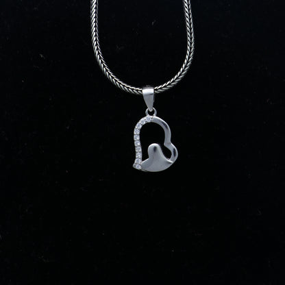 925 Sterling silver heart pendant with diamond accents by TRIBAL ORNAMENTS, featuring intricate tribal design.