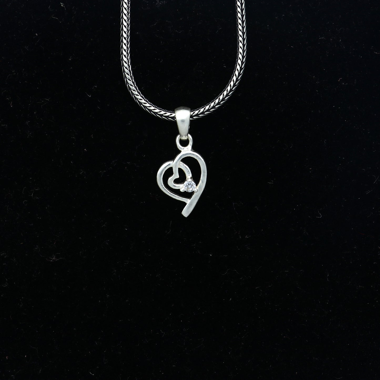 Sterling silver diamond heart pendant by Tribal Ornaments, featuring intricate heart design with sparkling diamonds.