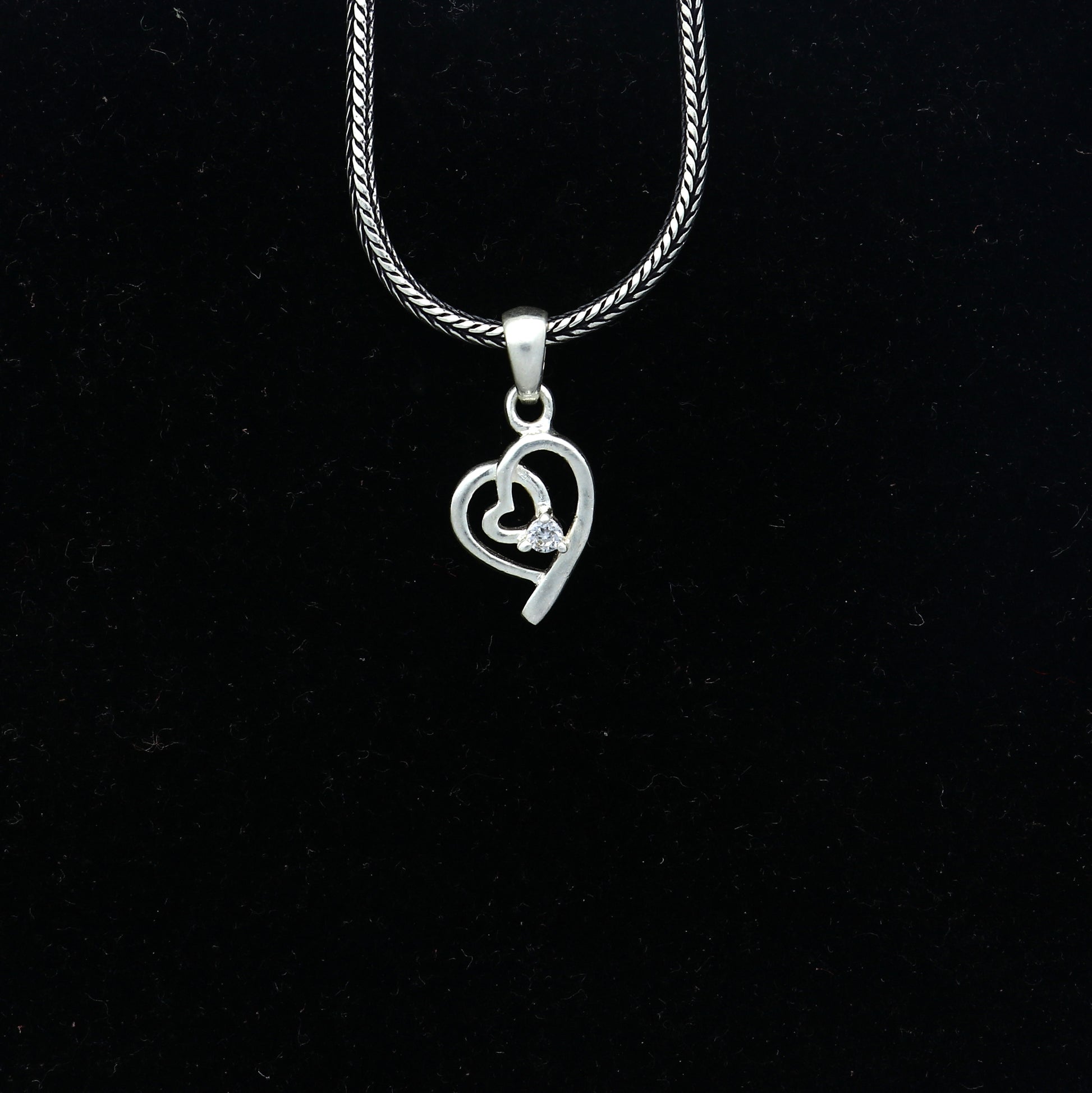 Sterling silver diamond heart pendant by Tribal Ornaments, featuring intricate heart design with sparkling diamonds.