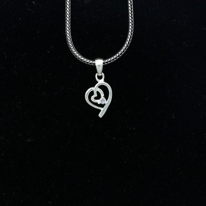 Sterling silver diamond heart pendant by Tribal Ornaments, featuring intricate heart design with sparkling diamonds.