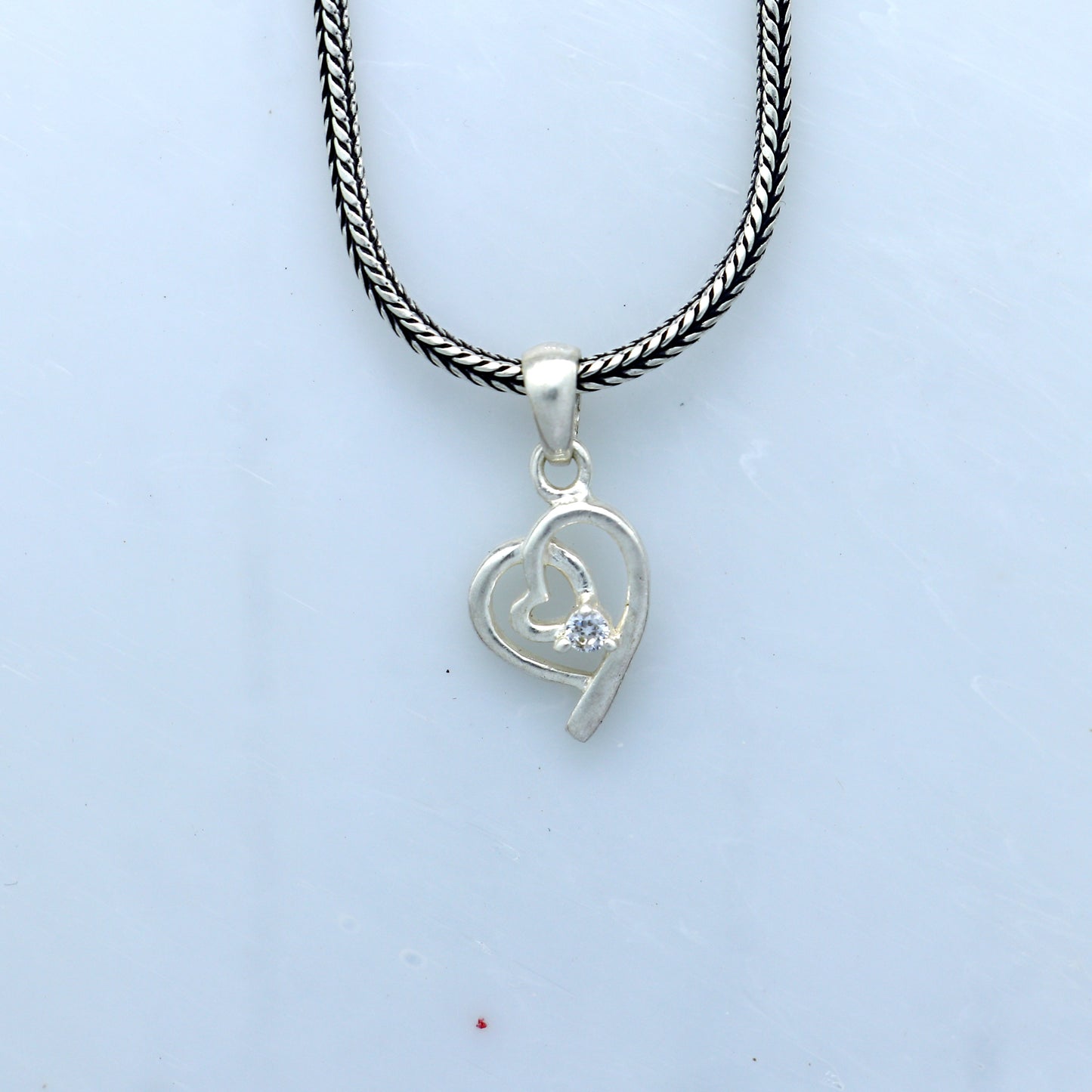 Sterling silver diamond heart pendant by Tribal Ornaments, featuring intricate heart design and sparkling embedded diamonds.