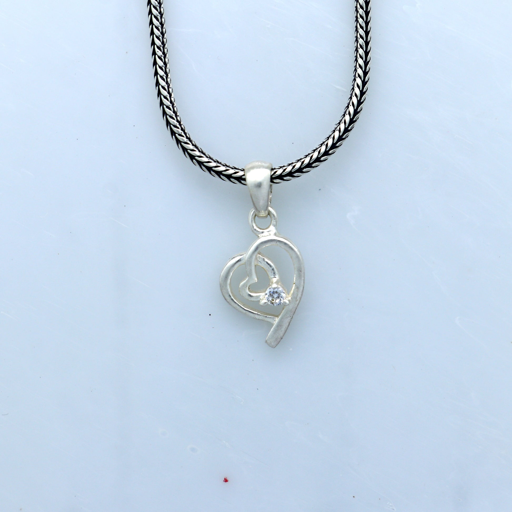Sterling silver diamond heart pendant by Tribal Ornaments, featuring intricate heart design and sparkling embedded diamonds.