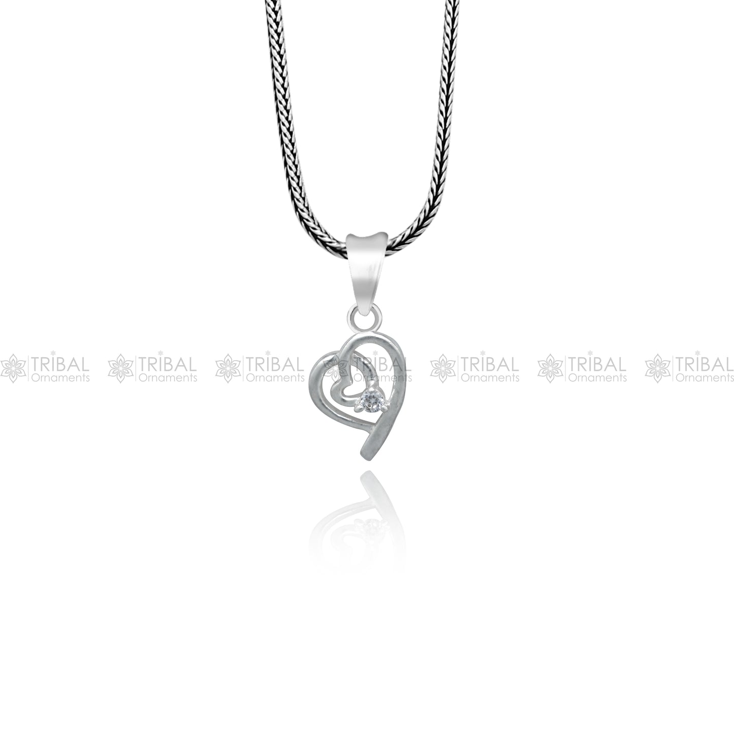 Sterling silver diamond heart pendant by Tribal Ornaments with intricate design, featuring sparkling diamond accents.
