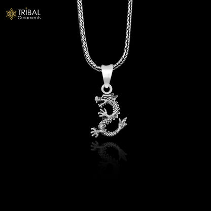 Sterling silver vintage dragon pendant by TRIBAL ORNAMENTS, featuring intricate tribal design, for boys and girls, stylish jewelry piece.