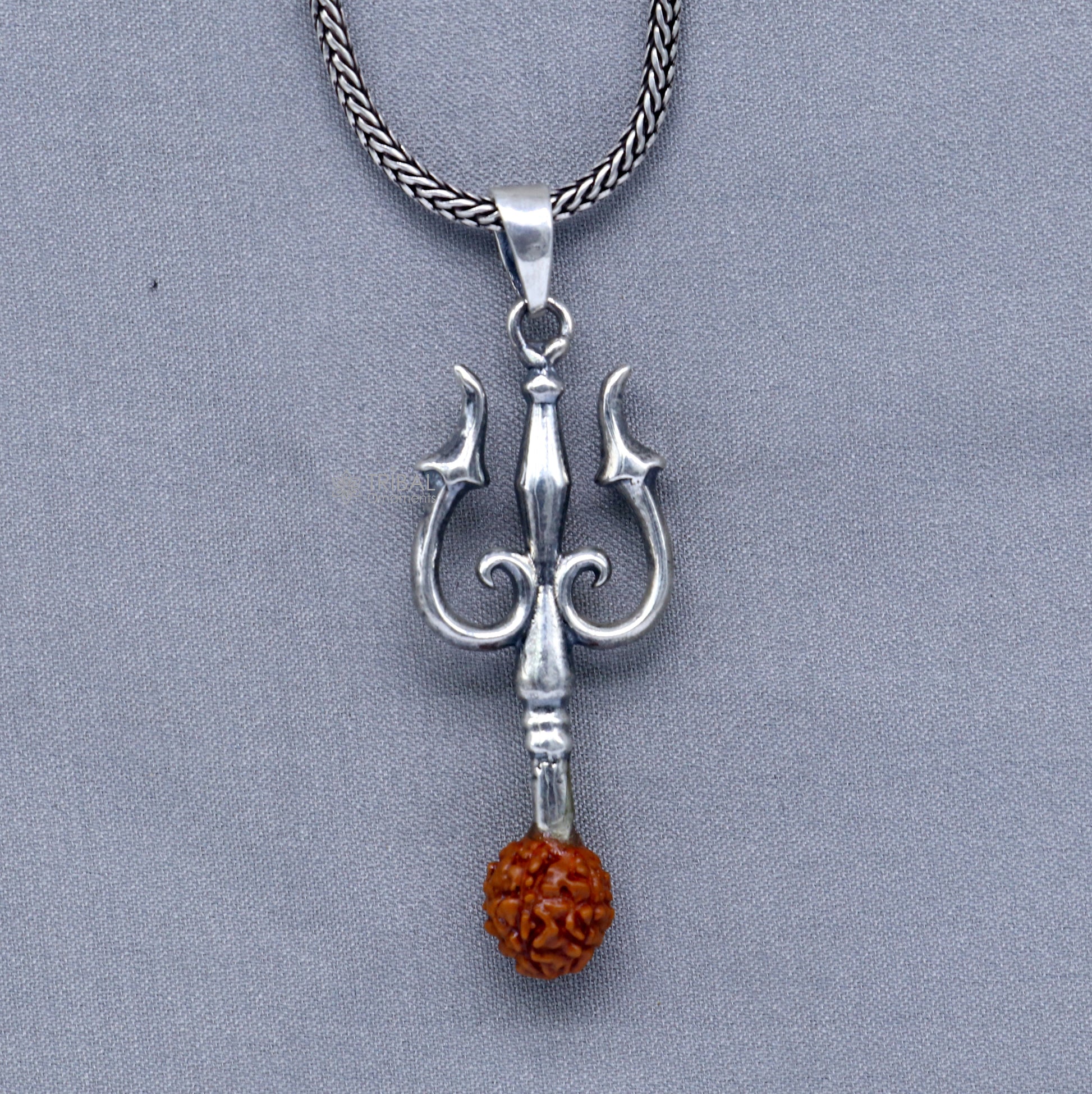 925 Sterling silver handmade Trishul pendant with Rudraksha bead, crafted by TRIBAL ORNAMENTS, featuring a detailed trident design.
