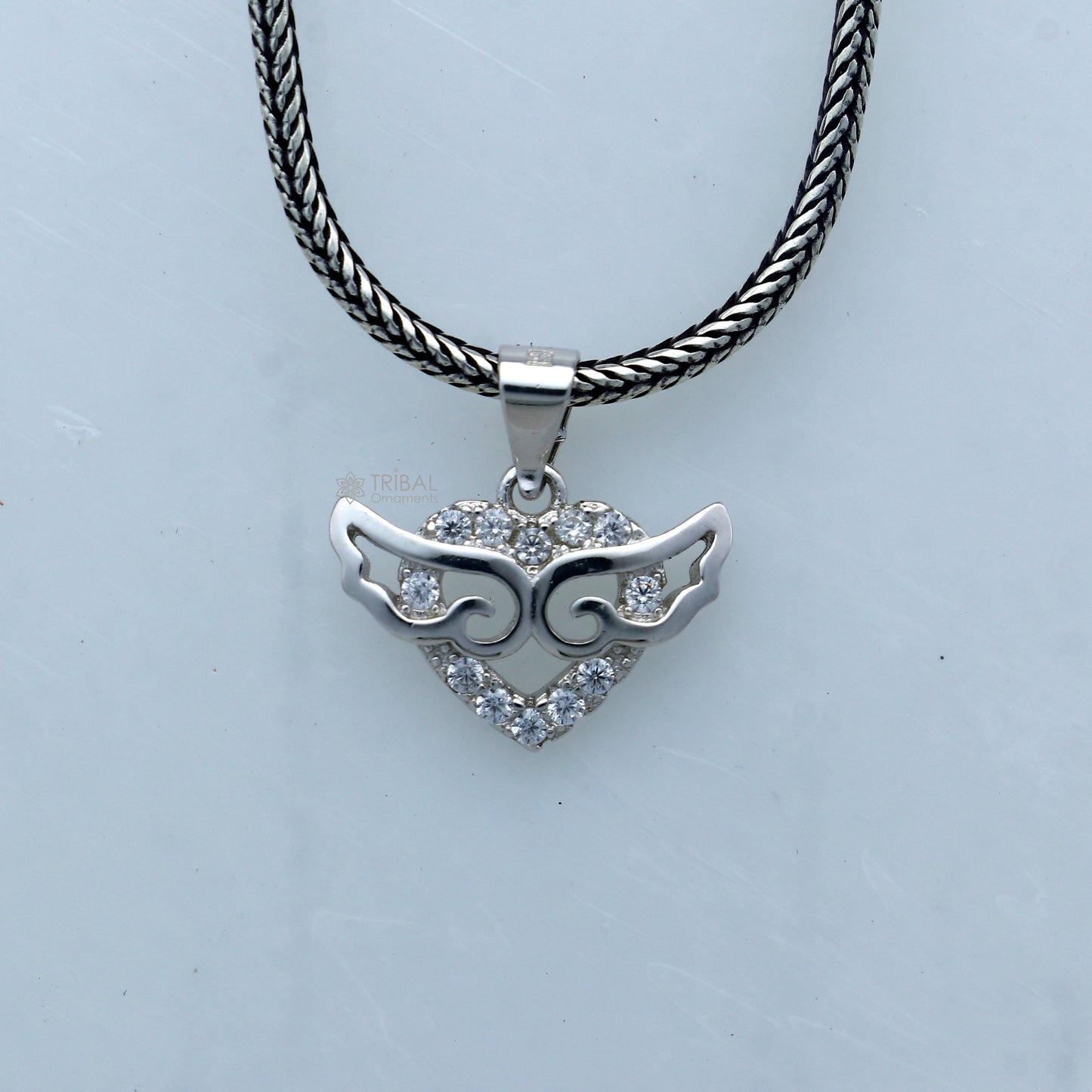 925 Sterling silver handmade pendant with unique tribal design by TRIBAL ORNAMENTS, featuring intricate craft details.