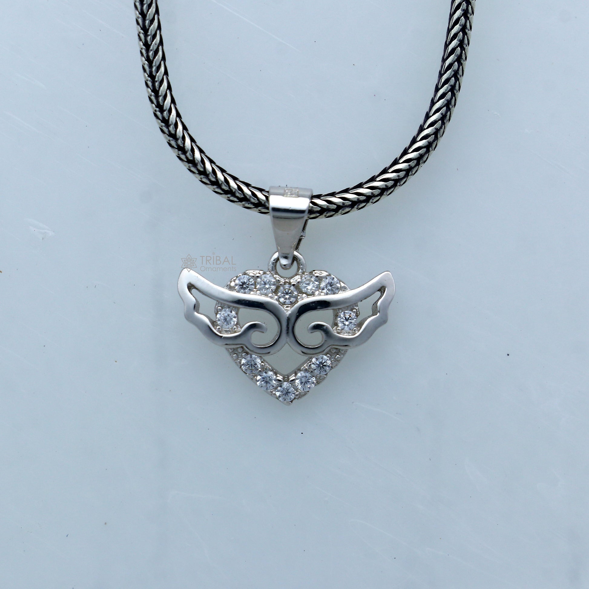 925 Sterling silver handmade pendant with unique tribal design by TRIBAL ORNAMENTS, featuring intricate craft details.