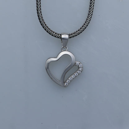 Sterling silver heart-shaped diamond pendant by Tribal Ornaments, featuring a detailed design and sparkling diamonds.