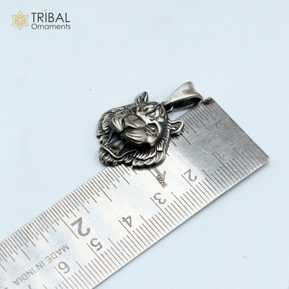 Sterling silver lion face pendant with chain, tribal jewelry by TRIBAL ORNAMENTS, featuring detailed tribal design elements.