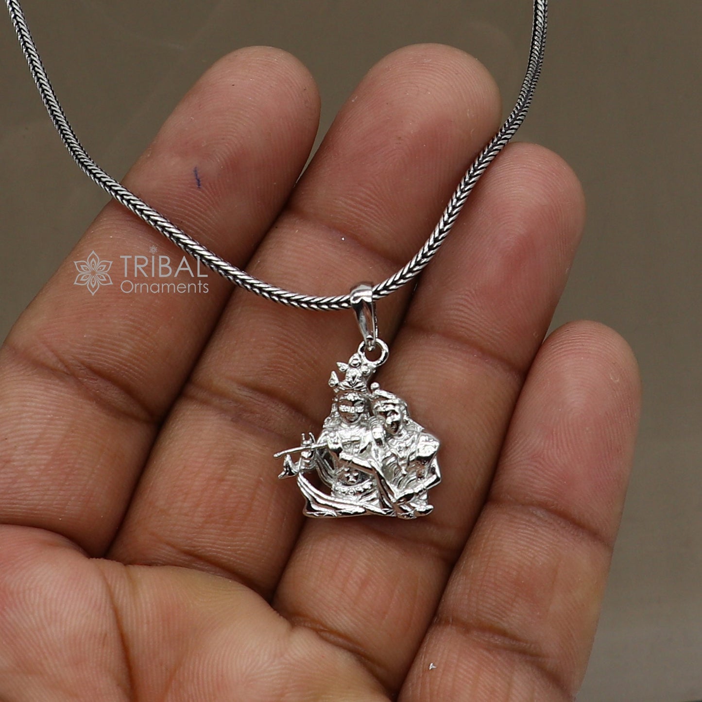 925 sterling silver Lord Krishna and Radha pendant, tribal jewelry featuring divine motifs, intricate craftsmanship.