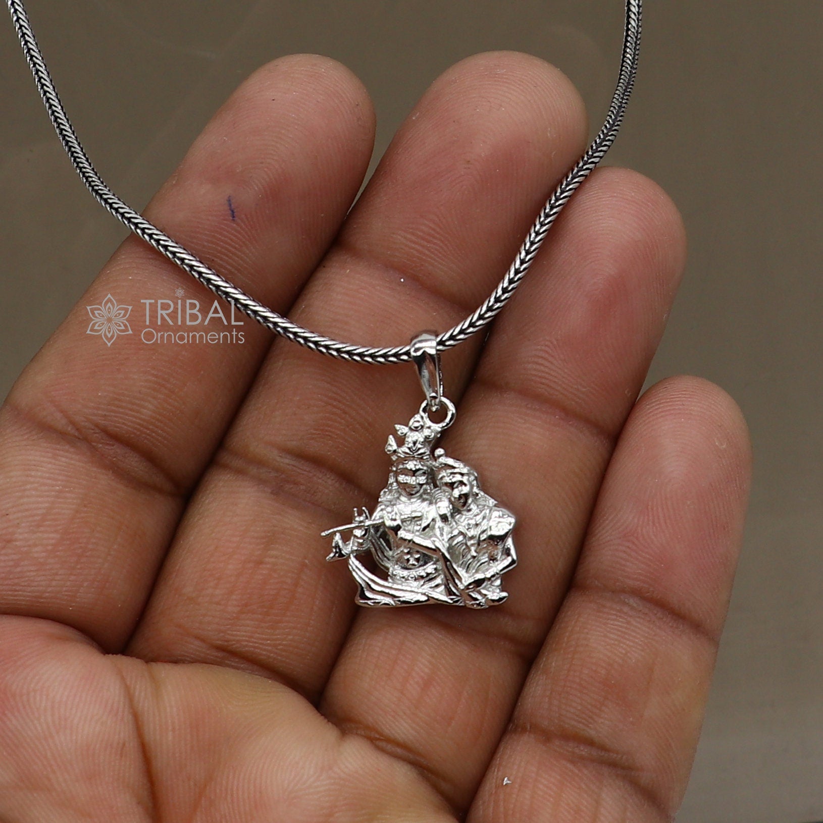 925 sterling silver Lord Krishna and Radha pendant, tribal jewelry featuring divine motifs, intricate craftsmanship.