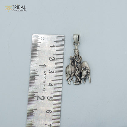 Sterling silver Lord Krishna with cow pendant on chain, tribal jewelry featuring detailed Hindu deity and animal design.