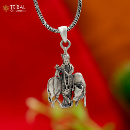 Sterling silver Lord Krishna with cow pendant on chain, tribal jewelry design, detailed religious pendant with traditional motifs.