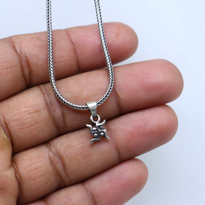 925 Sterling silver Swashtik pendant by TRIBAL ORNAMENTS featuring intricate tribal design on a polished silver surface.