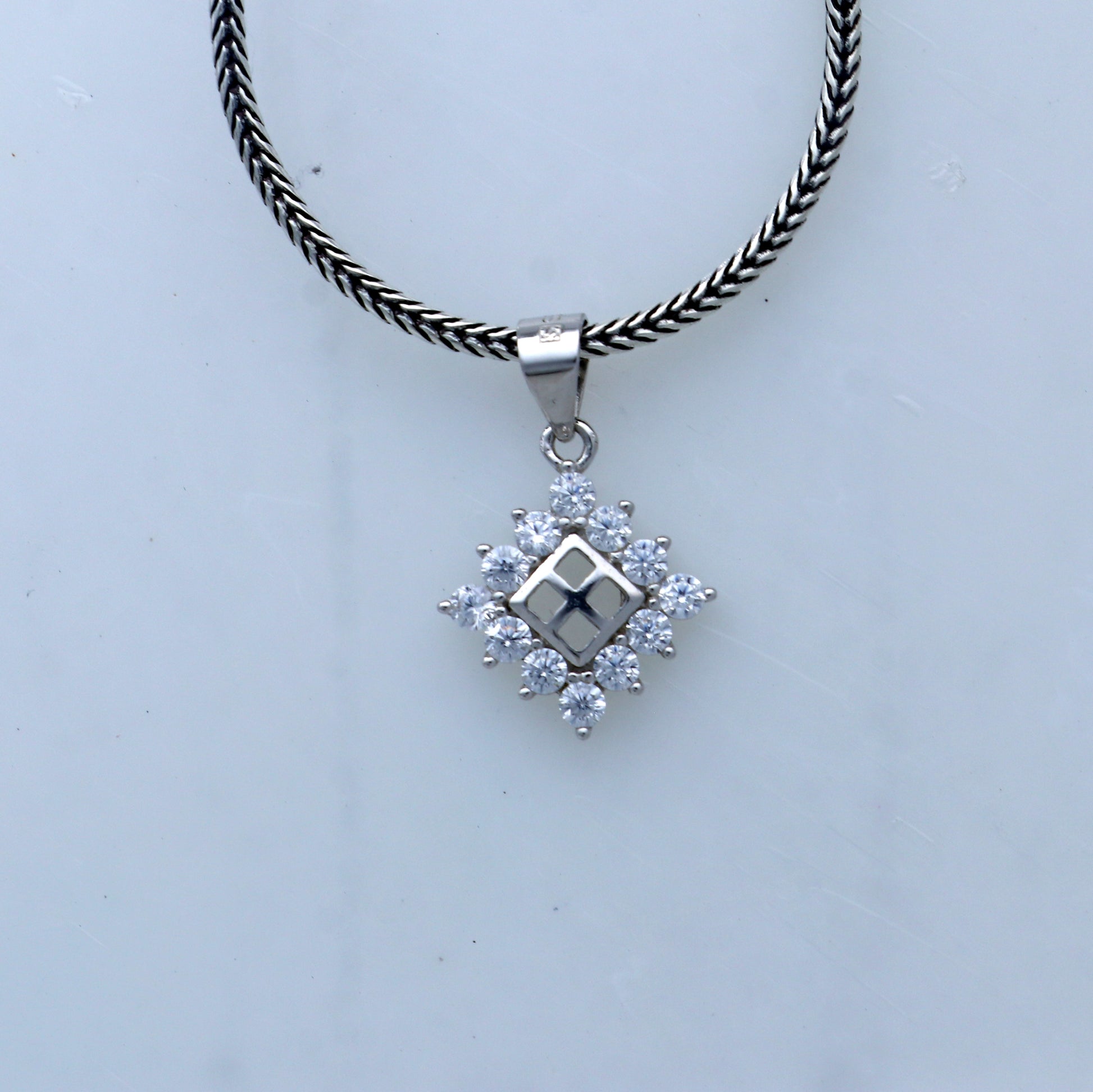 925 Sterling silver diamond pendant with unique tribal design from TRIBAL ORNAMENTS, showcasing intricate craftsmanship and sparkling diamonds.