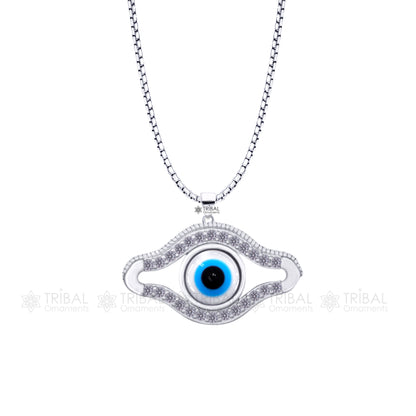 Pure 925 sterling silver evil eyes pendant with sparkling CZ stone, from TRIBAL ORNAMENTS, featuring intricate tribal design.