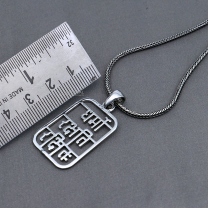 Handmade 925 sterling silver Dharmo Rakshathi Rakshitaha pendant by Tribal Ornaments, featuring intricate tribal design.
