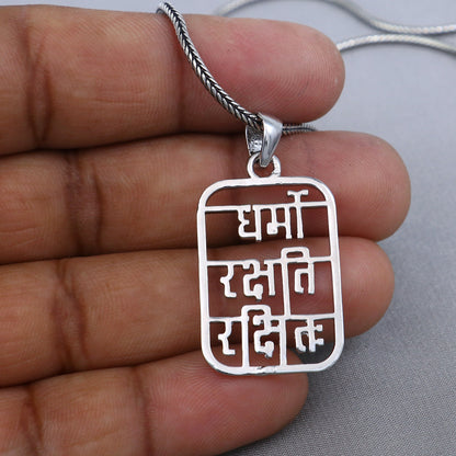 Sterling silver handmade Dharmo Rakshathi Rakshitaha pendant by Tribal Ornaments featuring intricate tribal design.