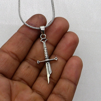 925 sterling silver small sword pendant by TRIBAL ORNAMENTS, handmade unisex jewelry with white finish and intricate design.