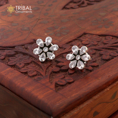 Sterling silver floral charm necklace set with CZ cut stones, featuring an 18-inch chain and stylish jewelry design.