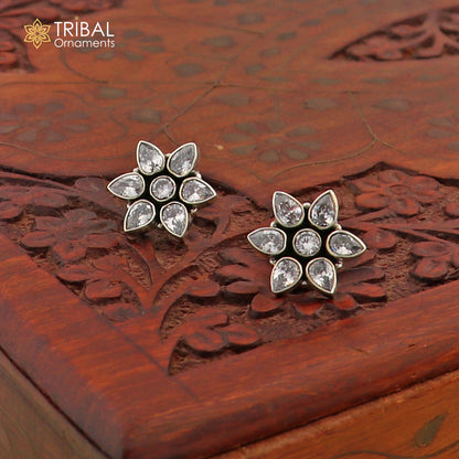 Sterling silver floral charm necklace set with CZ cut stones by Tribal Ornaments, featuring an 18-inch chain and intricate design.
