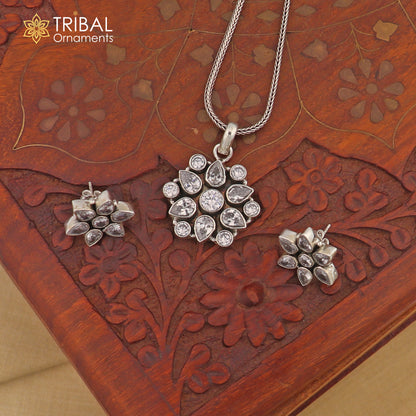 Sterling silver floral charm necklace set with CZ cut stones by TRIBAL ORNAMENTS, featuring an 18-inch chain and intricate design.