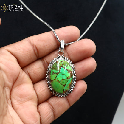 Unisex tribal jewelry pendant featuring a round green turquoise stone set in 925 sterling silver with an 18-inch chain.