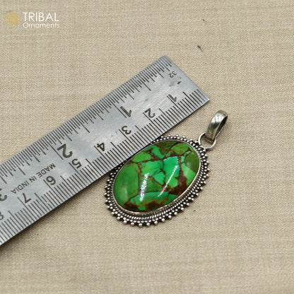 Unisex tribal jewelry pendant featuring a round green turquoise stone set in 925 sterling silver with an 18-inch chain.