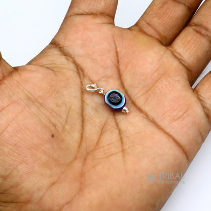 Sterling silver Evil Eye pendant by TRIBAL ORNAMENTS featuring a modern, trendy design to protect against negativity.