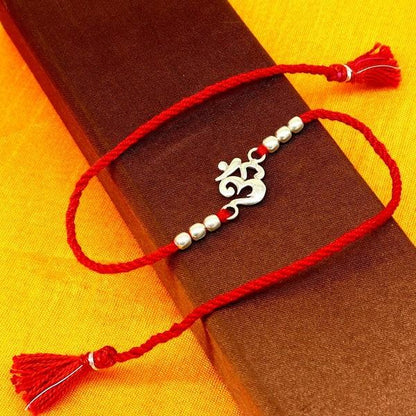 925 sterling silver OM design bracelet with red thread Rakhi, tribal ornaments, symbolic spiritual jewelry for Raksha Bandhan.