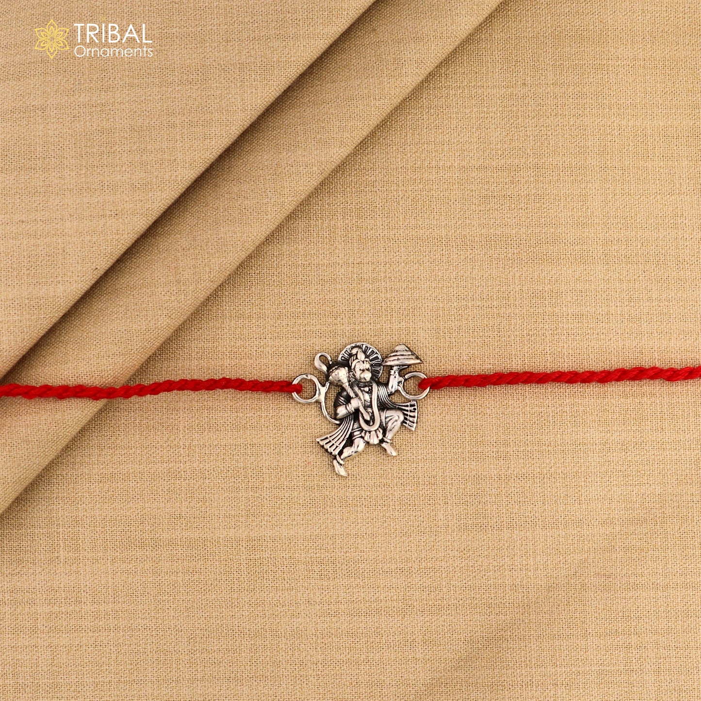 925 silver Flying Hanuman idol Rakhi with red thread, traditional Indian bracelet from Tribal Ornaments for Raksha Bandhan.
