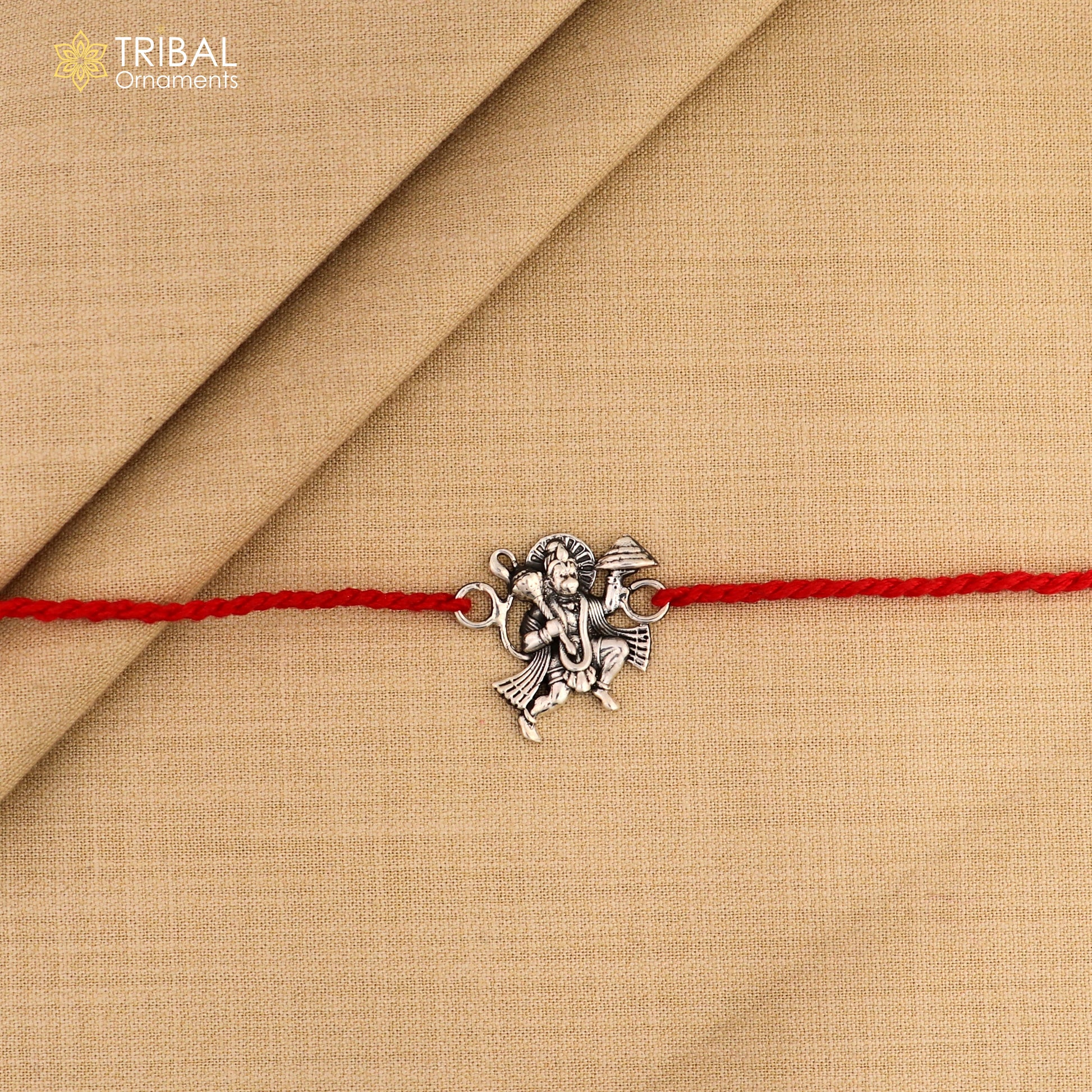 925 silver Flying Hanuman idol Rakhi with red thread, traditional Indian bracelet from Tribal Ornaments for Raksha Bandhan.