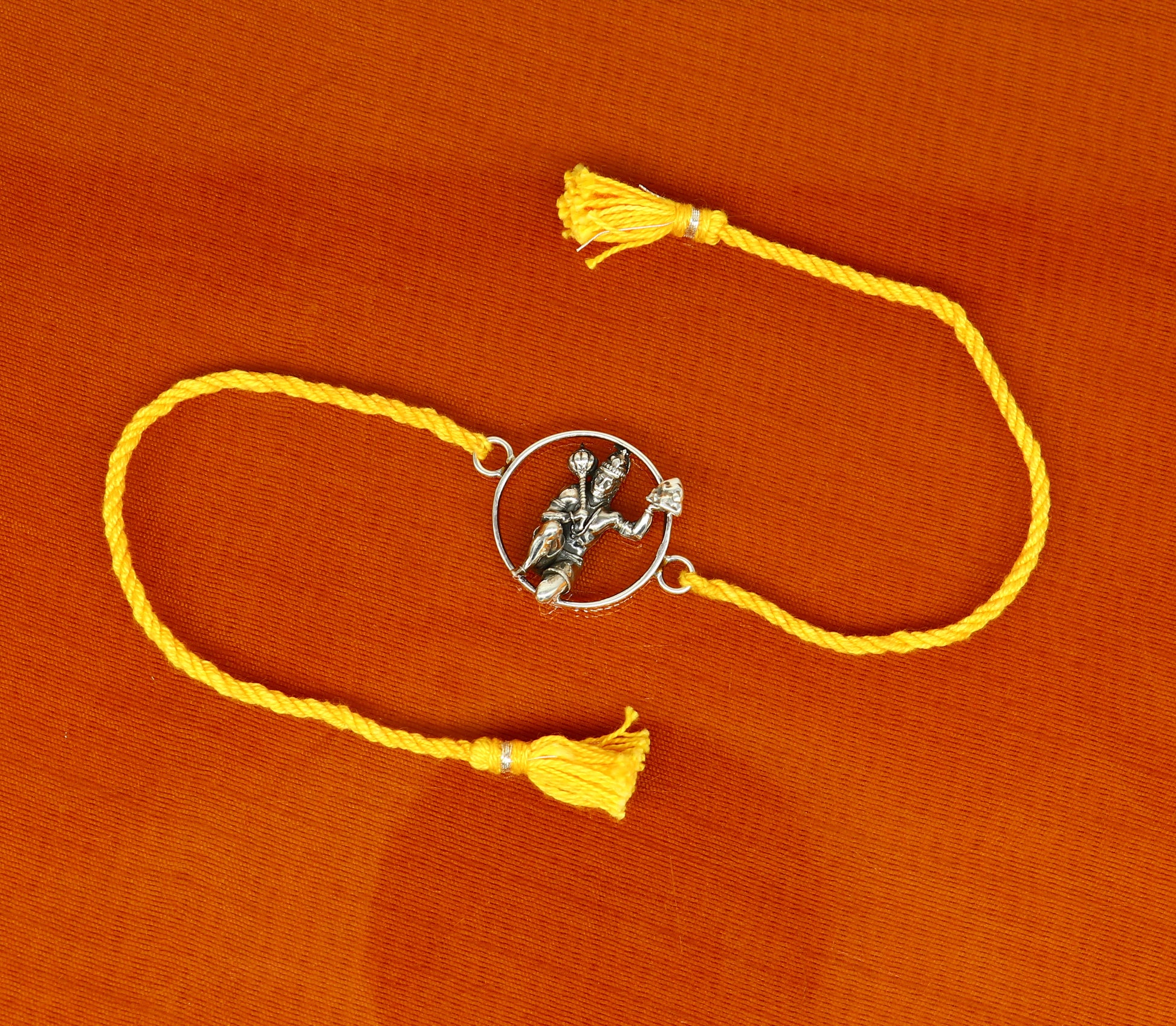 925 sterling silver Hanuman idol bracelet with red thread rakhi, tribal ornaments design, featuring intricate craftsmanship and vibrant red thread.