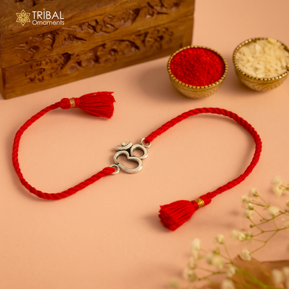 925 sterling silver OM design bracelet with yellow thread Rakhi, featuring custom tribal ornament craftsmanship and intricate detailing.