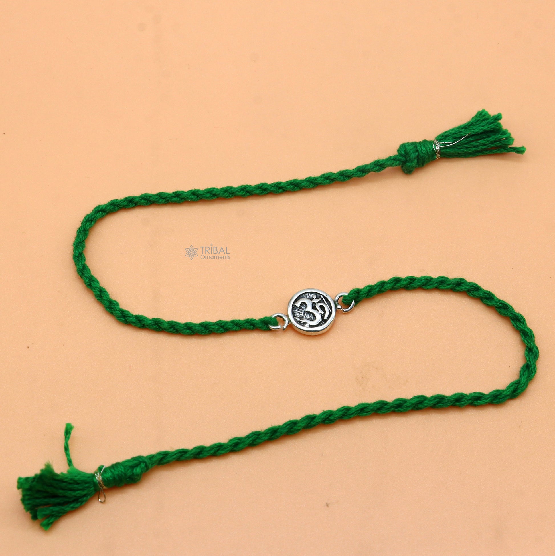 925 Sterling silver Hindu mantra "Aum" thread rakhi bracelet with red thread and silver pendant, designed by Tribal Ornaments.