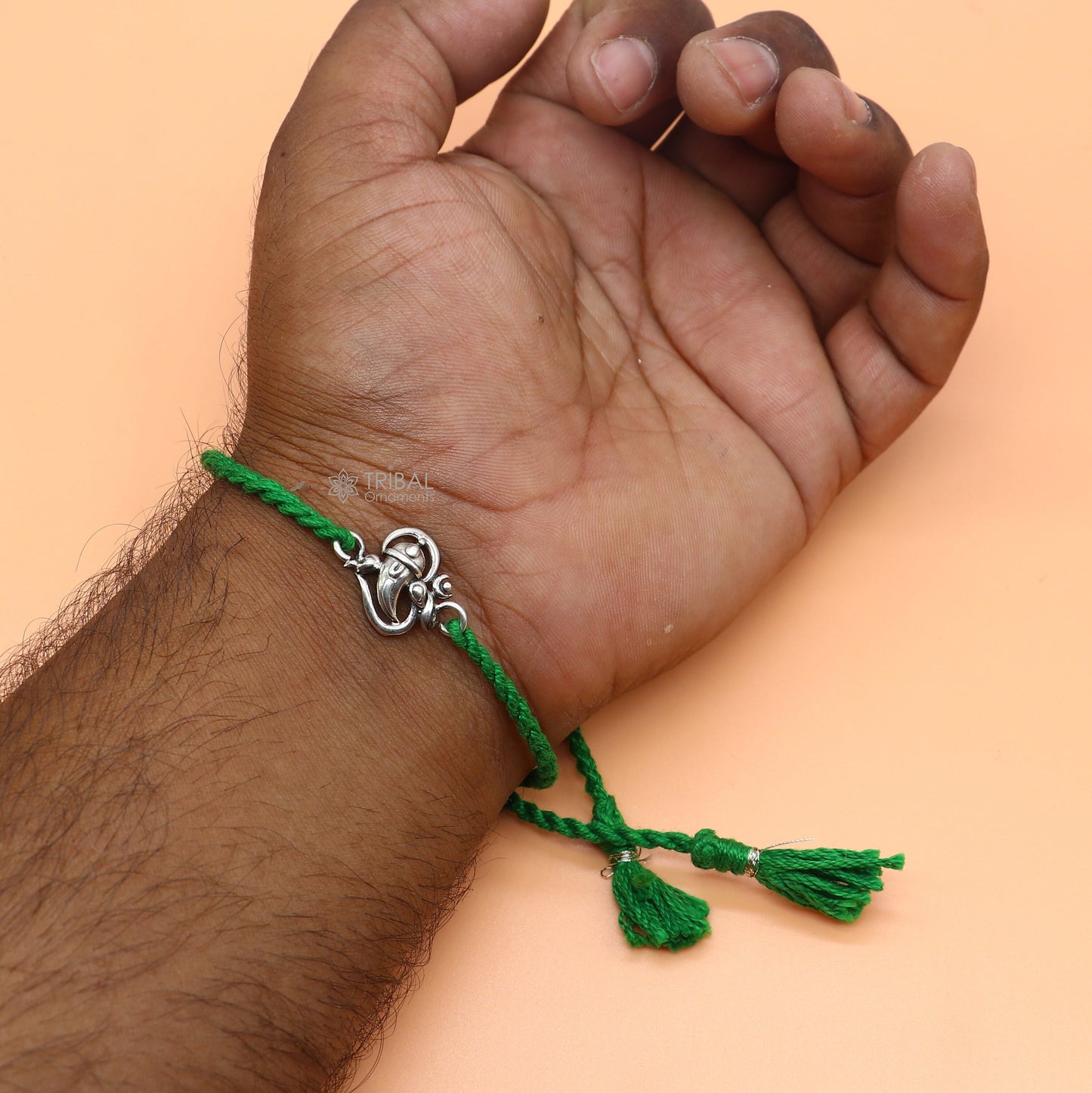 Sterling silver Lord Ganesha OM design pendant bracelet with red thread, tribal ornaments brand, traditional thread rakhi bracelet.