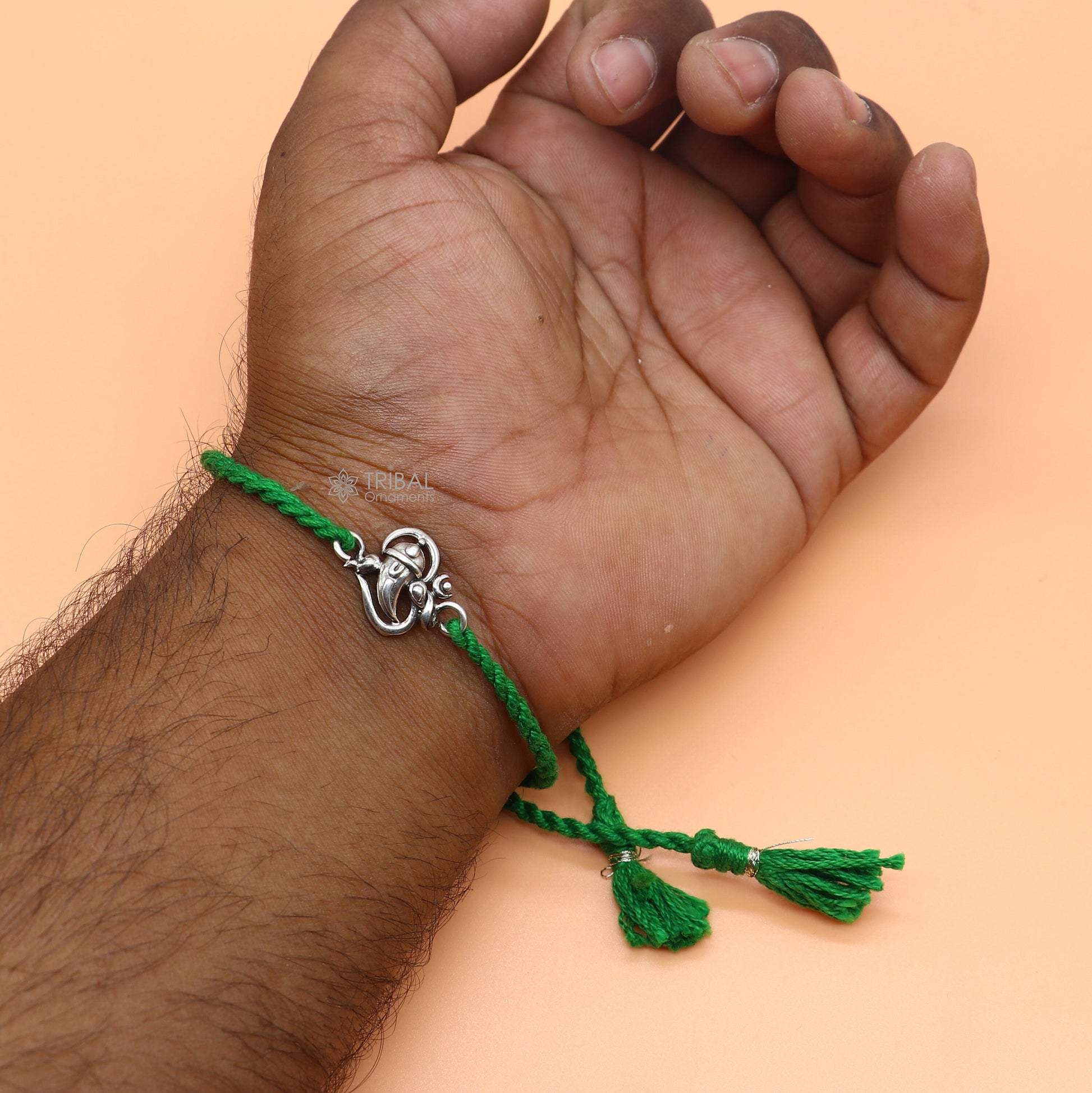 Sterling silver Lord Ganesha OM design pendant bracelet with red thread, tribal ornaments brand, traditional thread rakhi bracelet.