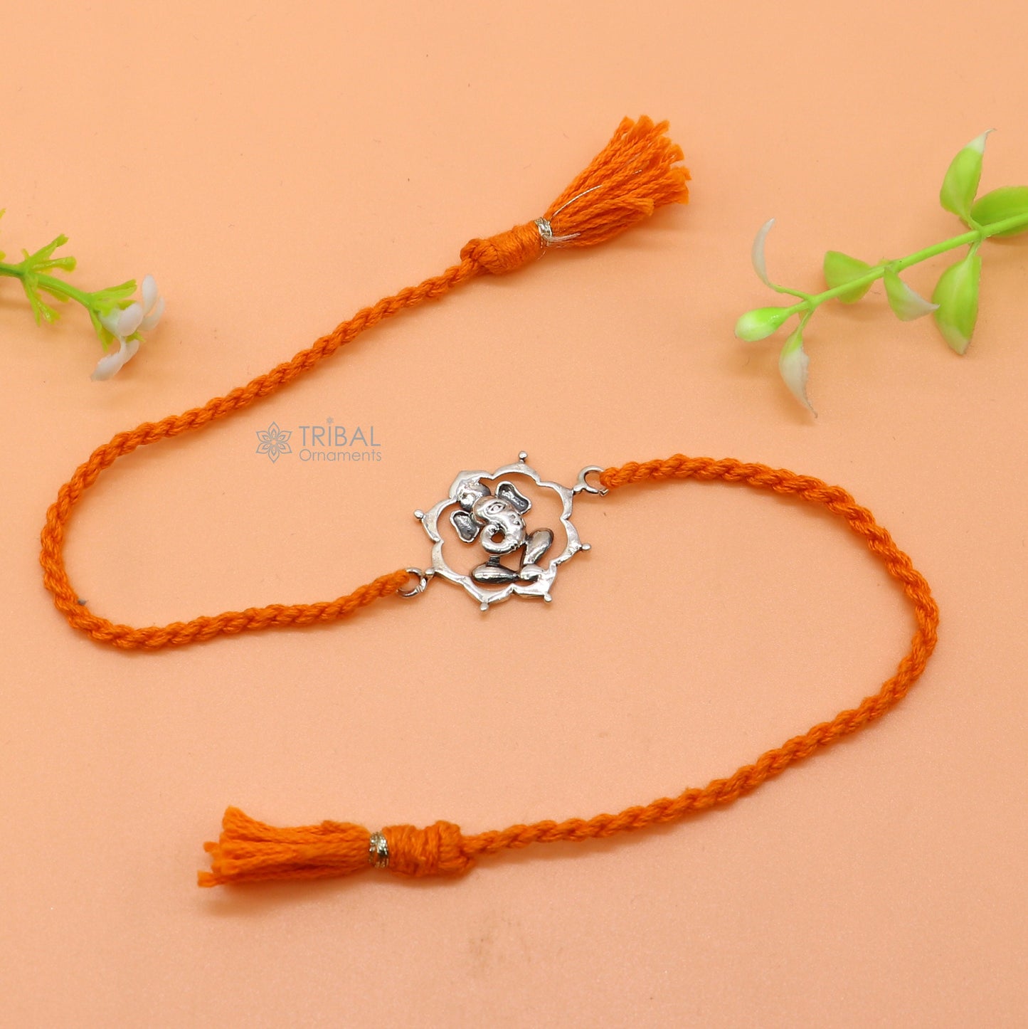 Sterling silver Lord Ganesha pendant on red thread bracelet from Tribal Ornaments, featuring intricate design and traditional craftsmanship.