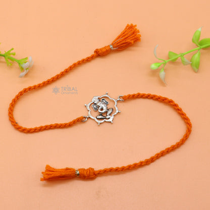 Sterling silver Lord Ganesha pendant on red thread bracelet from Tribal Ornaments, featuring intricate design and traditional craftsmanship.