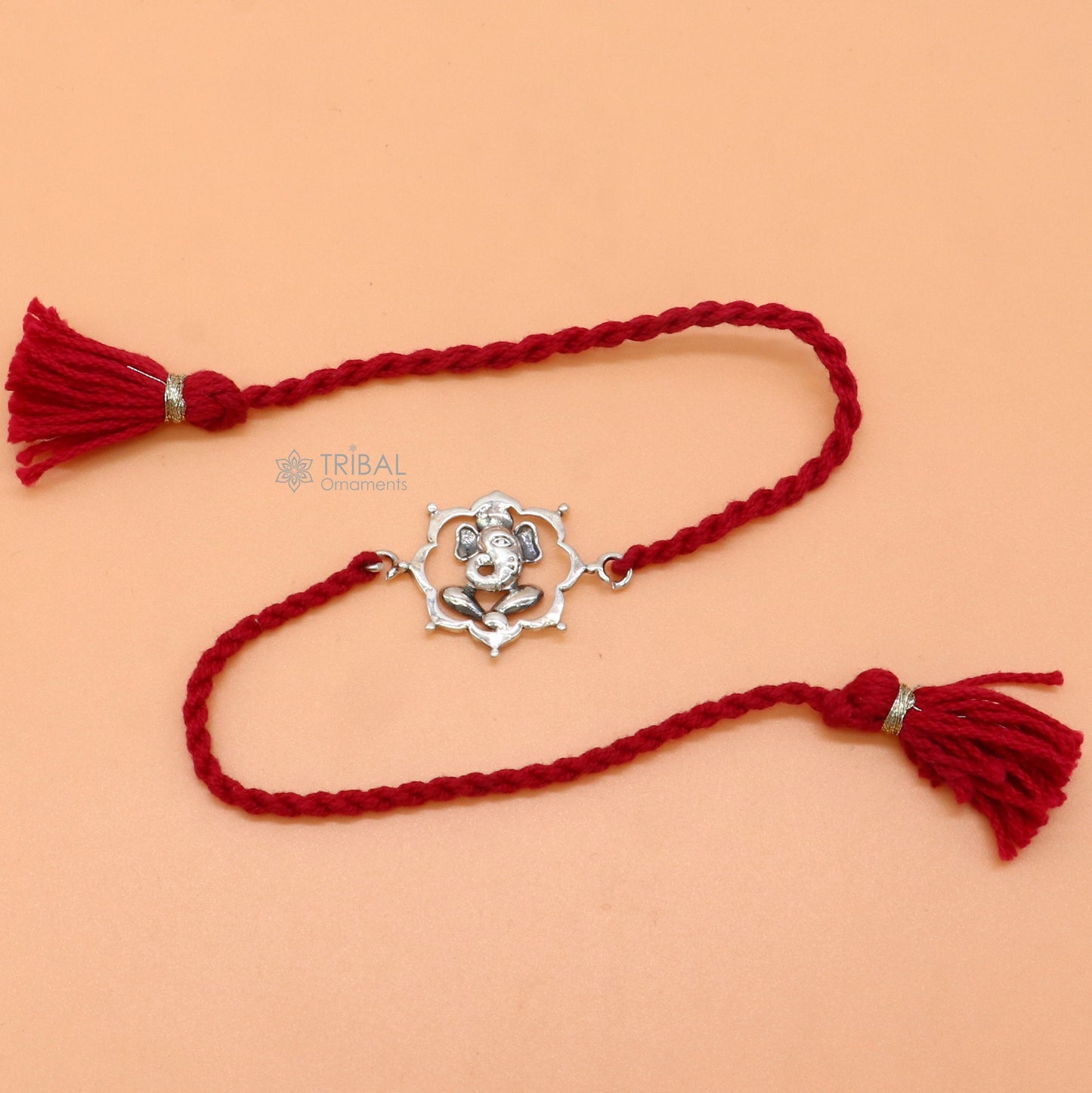 925 Sterling silver Lord Ganesha thread rakhi bracelet with red thread and Ganesha pendant, crafted by TRIBAL ORNAMENTS.