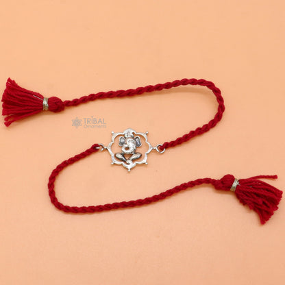 925 Sterling silver Lord Ganesha thread rakhi bracelet with red thread and Ganesha pendant, crafted by TRIBAL ORNAMENTS.