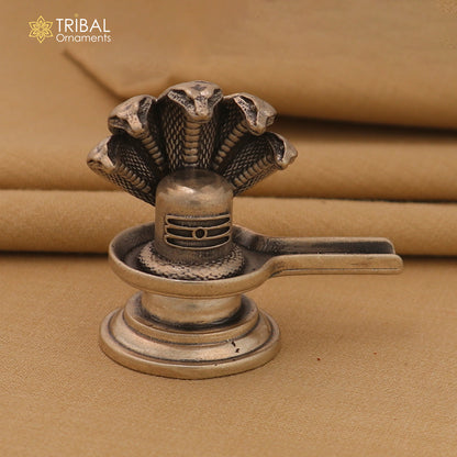 Shiny 925 sterling silver Lord Shiva Lingam for home temple, crafted by TRIBAL ORNAMENTS, featuring intricate divine Shiva design.