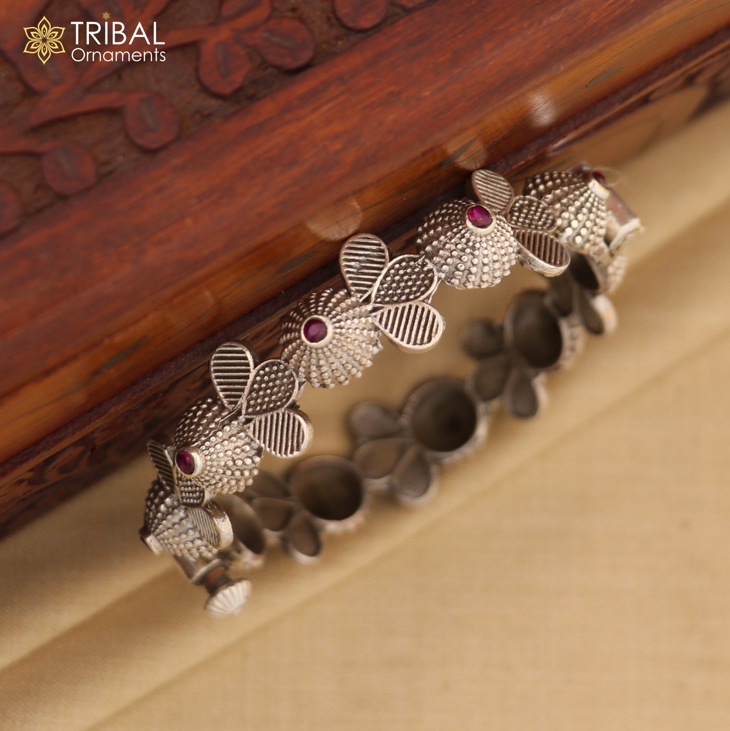Sterling silver tribal bangle bracelet with red stone accents, featuring traditional cultural design, perfect for wedding jewelry.