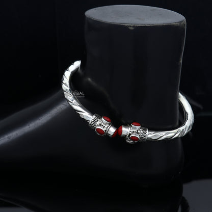 Sterling silver ankle kada bracelet with stylish design and vibrant coral stone by Tribal Ornaments, featuring intricate craftsmanship.